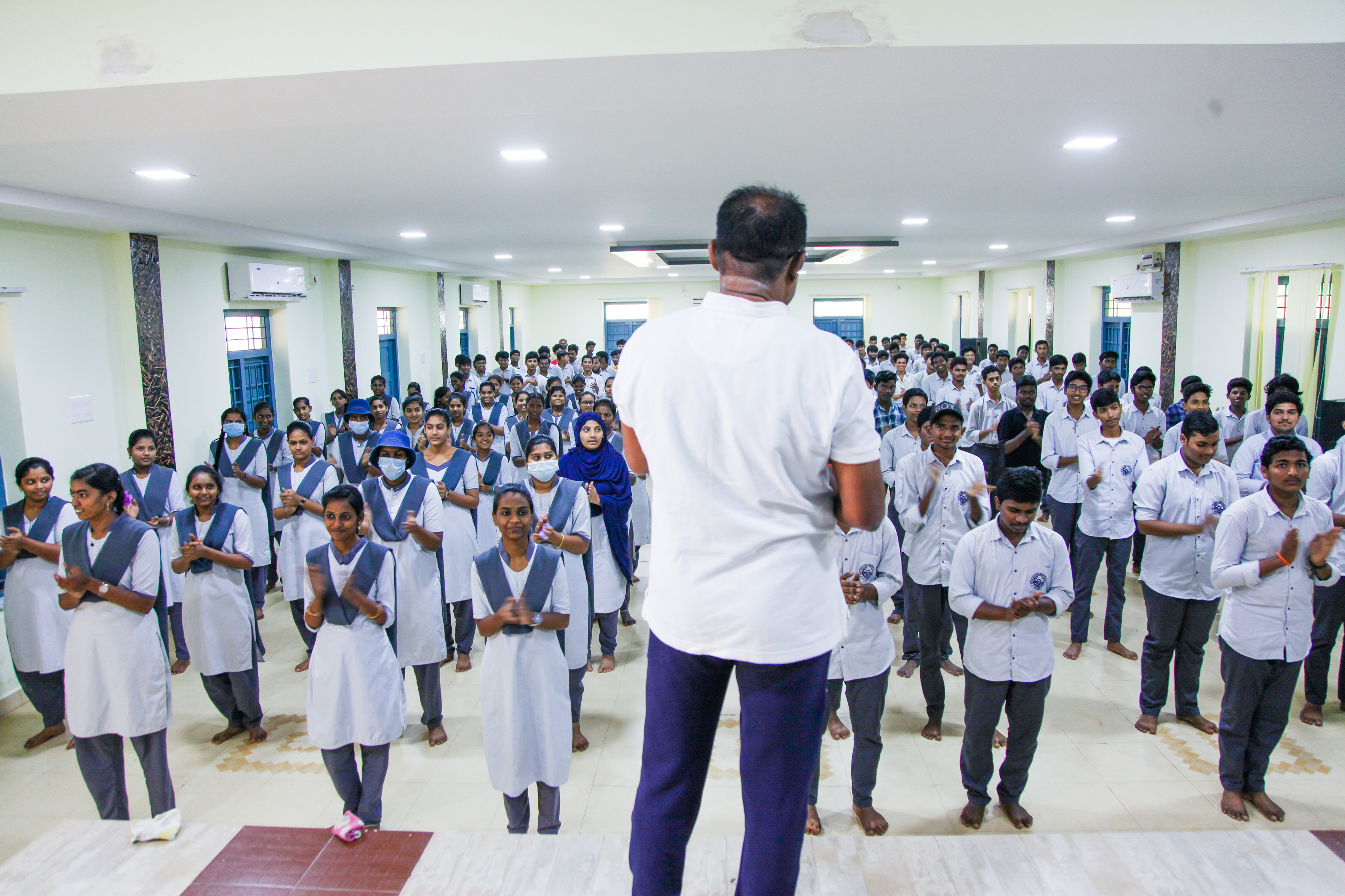 Students lining up in front of teacher