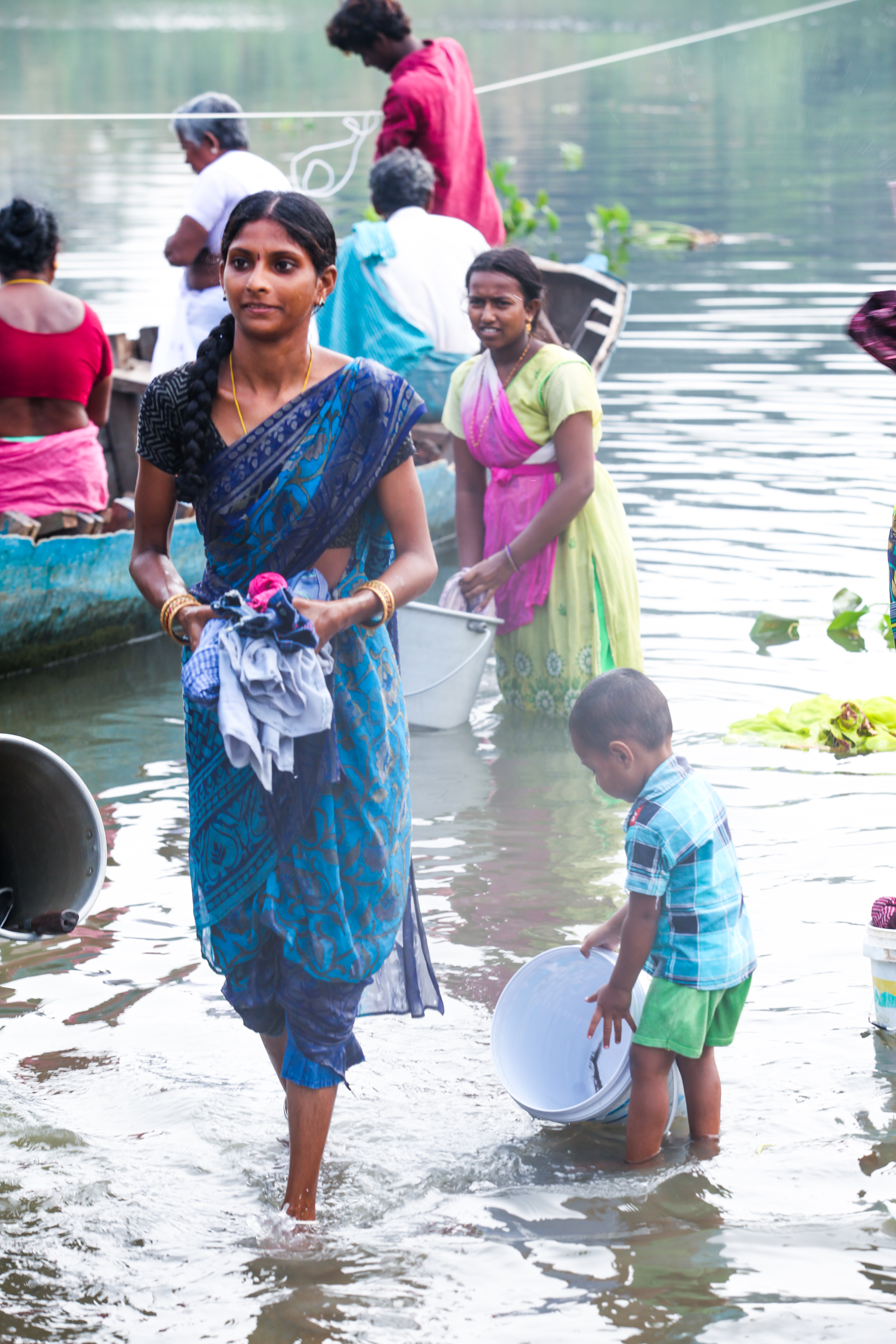 young woman doing laundry in river