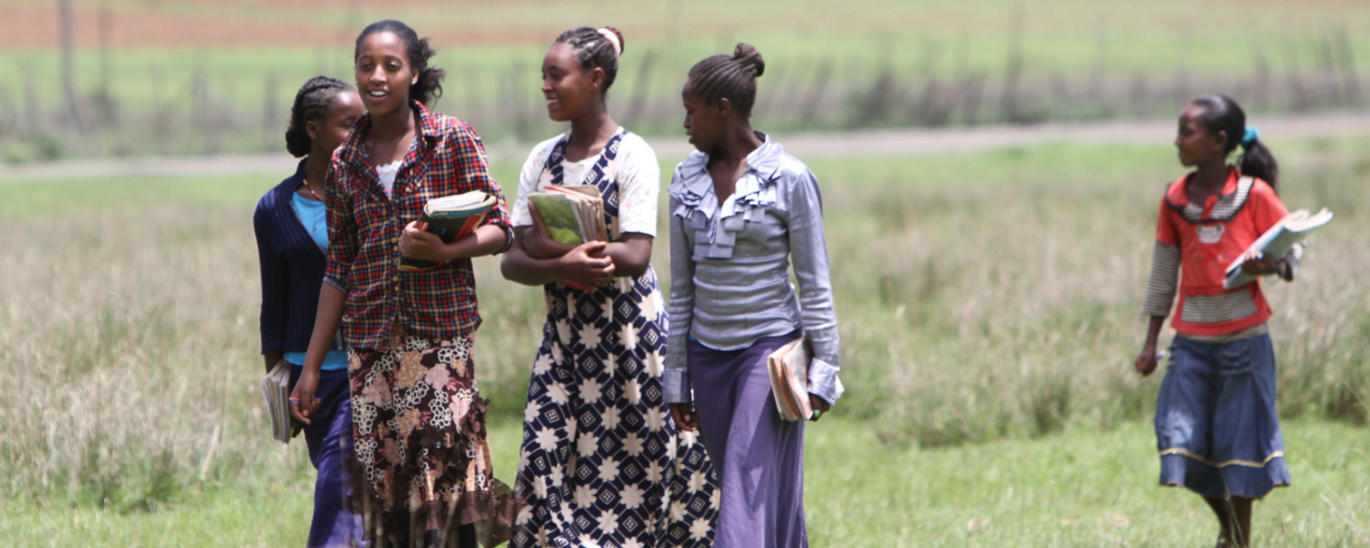group of girls walking holding school books