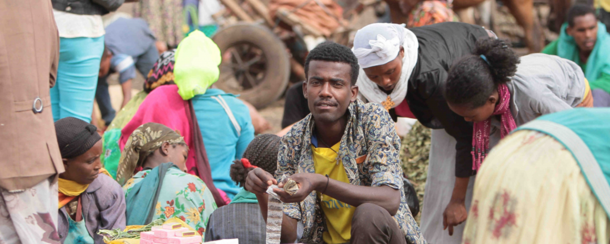 man sitting in a market place