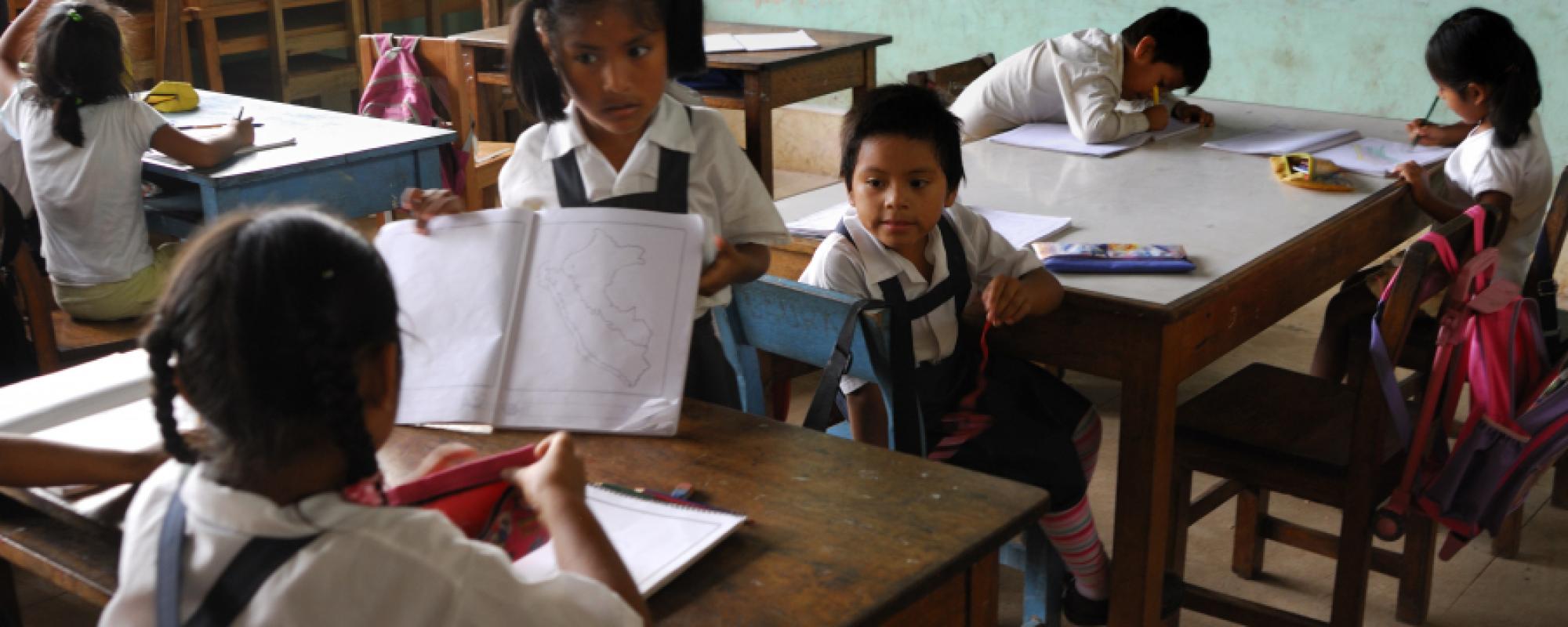small children in a classroom sharing books