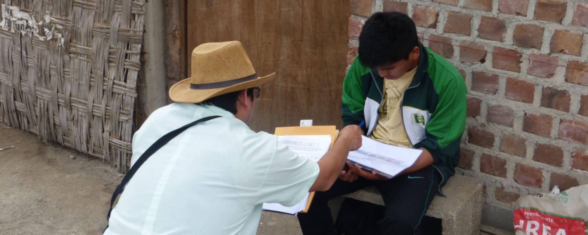 man showing a boy something in a book