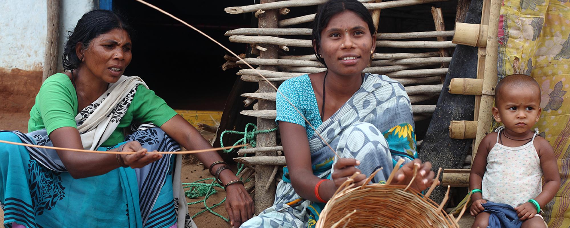 women weaving a basket 
