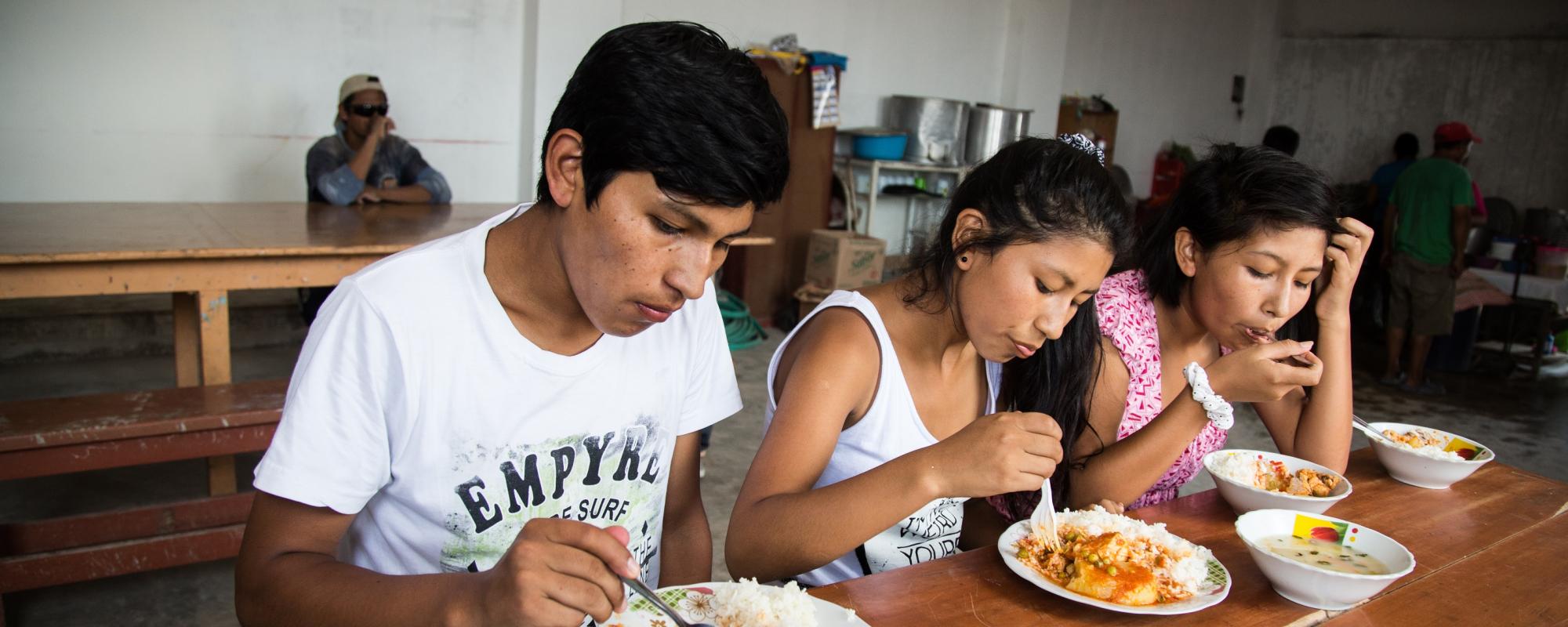 teenagers eating at a table