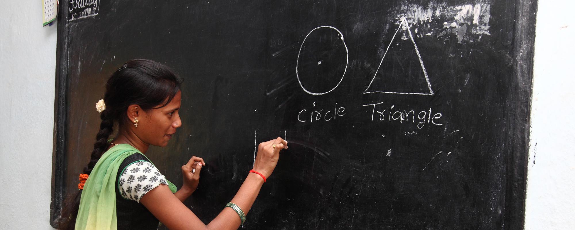 Girl in classroom at blackboard