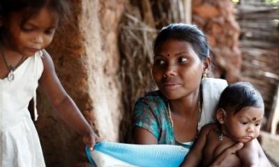 women with her two children sat outside