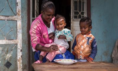 mother with two children sat at a table