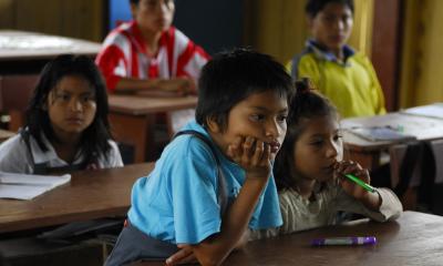 children sitting at desks in a classroom