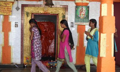 three girls in colourful clothing walking