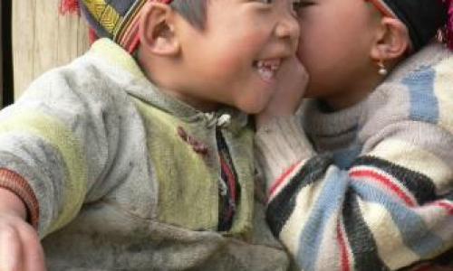 Two small boys whispering in Vietnam