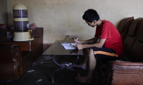 Young Vietnamese boy studying