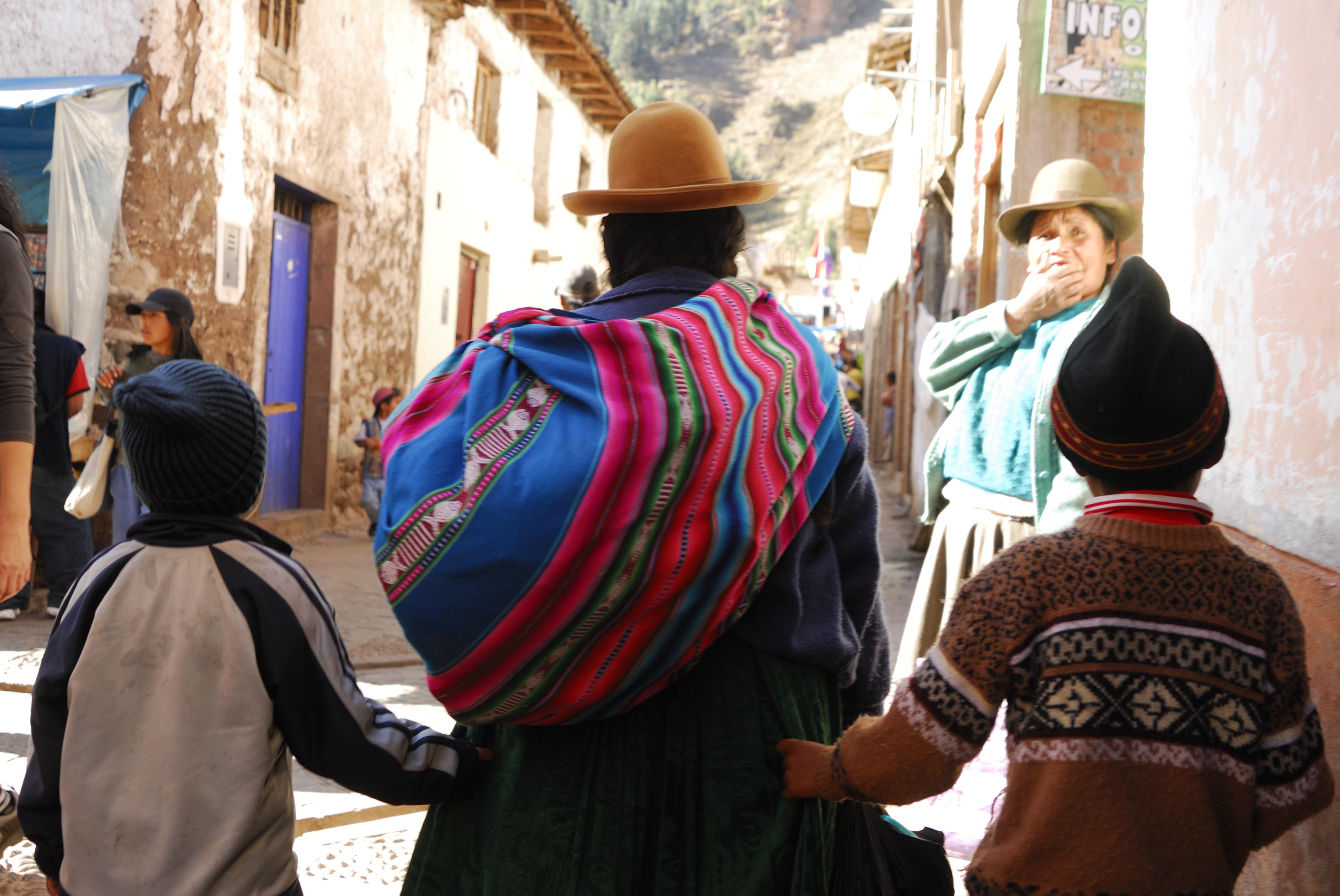 Women and two children walking up a street
