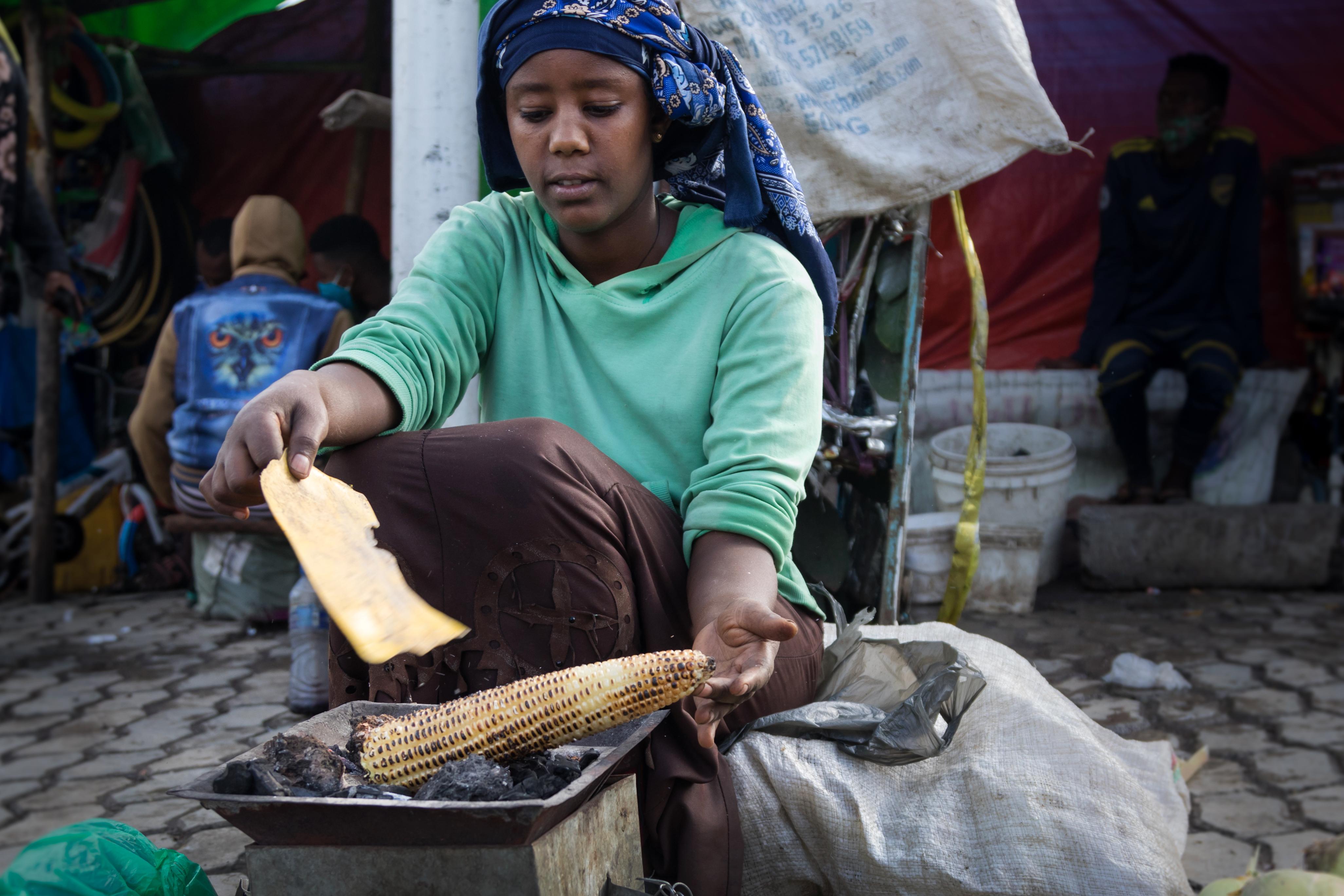 women cooking corn