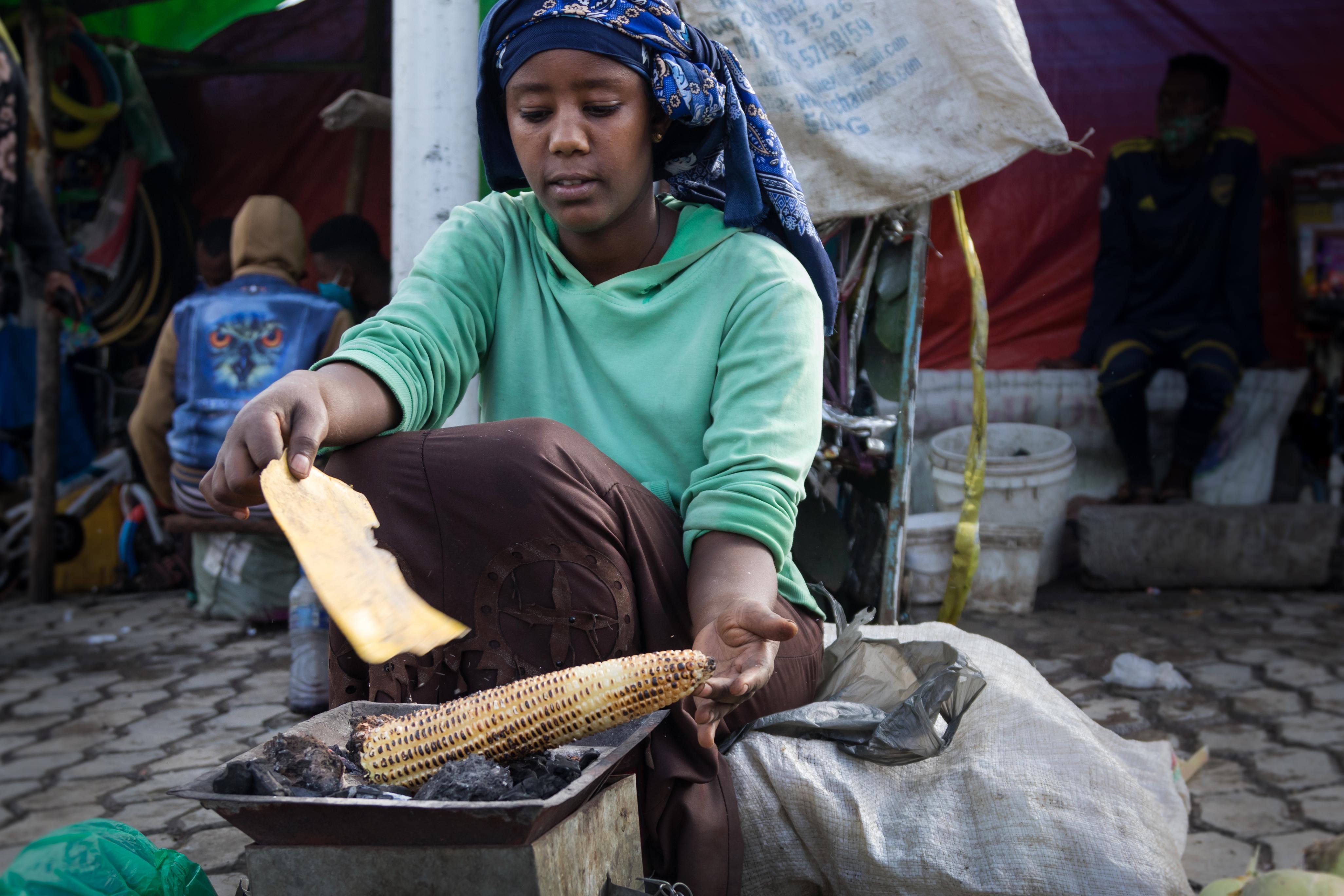 women cooking corn 