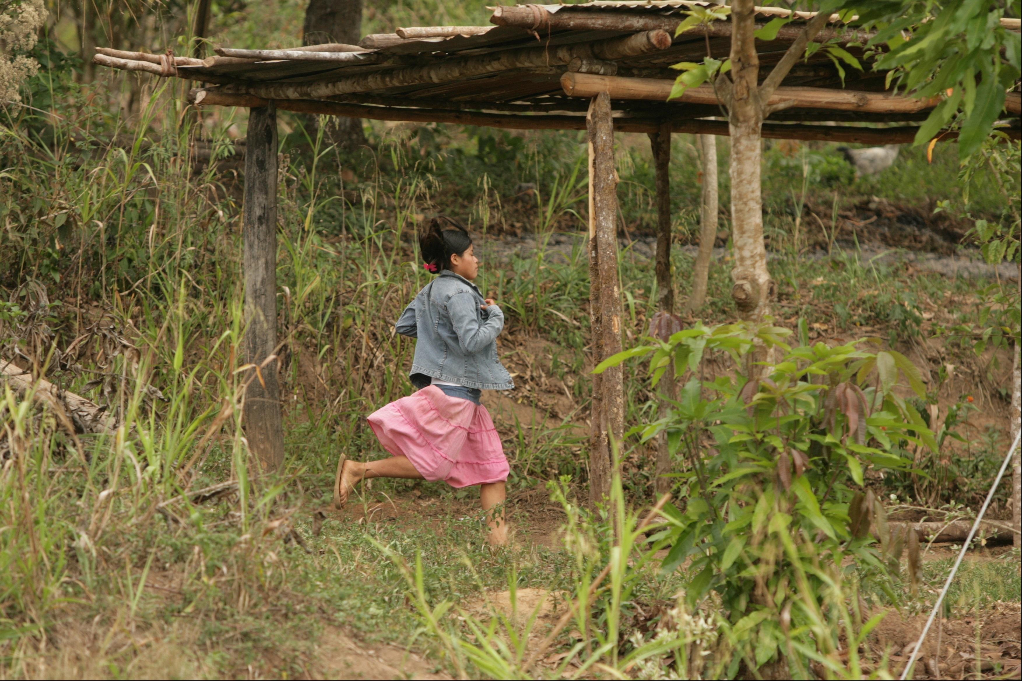 girl running through a field 