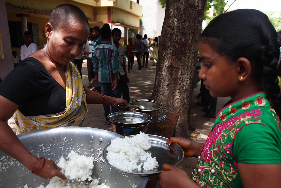 girl being served rice 