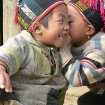 Two small boys whispering in Vietnam