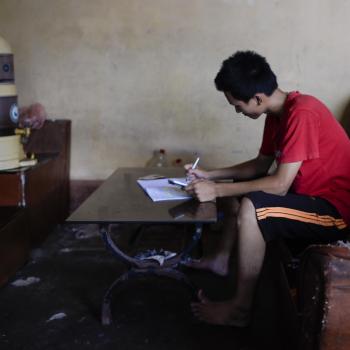 Young Vietnamese boy studying