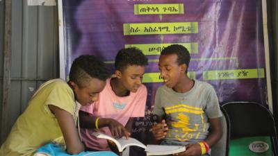 boys sat sharing a book