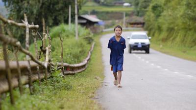 Young boy walking down the street