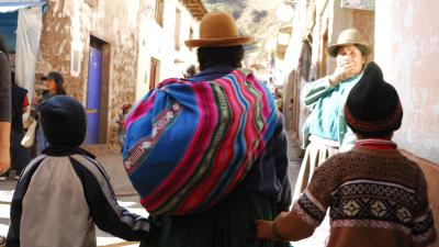 Women and two children walking up a street
