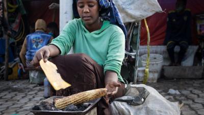 women cooking corn