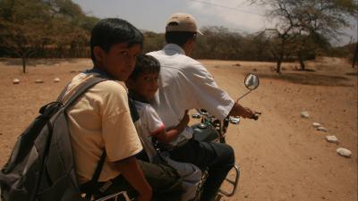 Father and two boys on a motorbike
