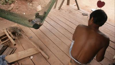 man watching his baby in a hammock