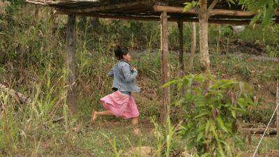 girl running through a field 