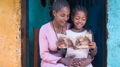mother reading to her daughter