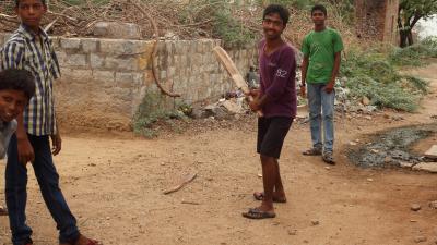 three men playing cricket