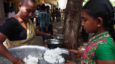 girl being served rice 