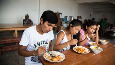 teenagers eating at a table