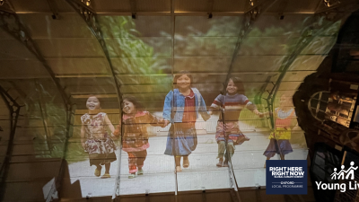 Pitt Rivers museum ceiling with an image of four Vietnamese children projected on it.
