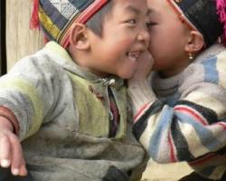 Two small boys whispering in Vietnam