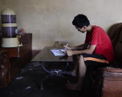 Young Vietnamese boy studying