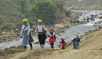 Children walking along a river
