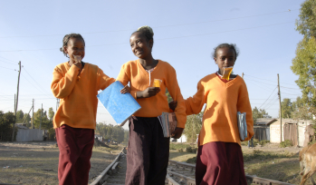 Three children walk to school