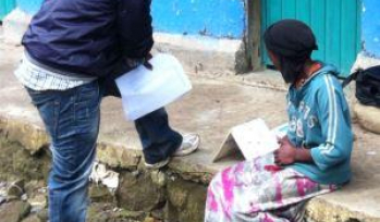Fieldworker interviewing a child