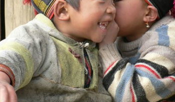 Two children whispering and playing
