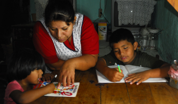 Mother helping children with their homework