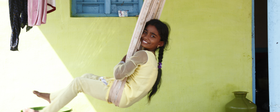 Child on a swing outside their house