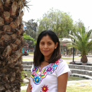 Katherine standing in a white top in front of a garden